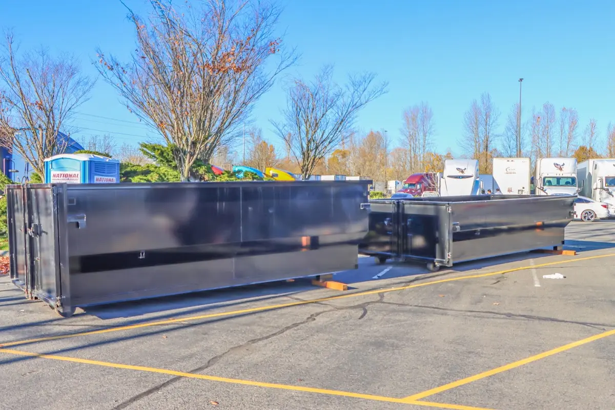 Professional dumpster rental service with roll-off container on residential driveway in Jordan